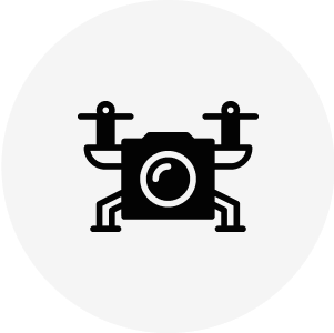Drone icon with camera and propellers.